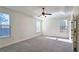 Spacious main bedroom featuring tray ceilings, large windows, and neutral carpeting at 6515 Bentley Ridge Dr, Cumming, GA 30040