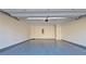 Spacious garage with epoxy flooring, ample space, and an automatic garage door at 6515 Bentley Ridge Dr, Cumming, GA 30040