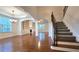 Spacious living room with hardwood floors, staircase, and built-in shelving at 6515 Bentley Ridge Dr, Cumming, GA 30040