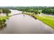 Aerial view of the golf course, lake, and connecting bridge on a sunny, green landscape at 2678 Neighborhood S Walk, Villa Rica, GA 30180