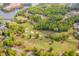 Overhead view of a lush golf course with manicured greens, water features, and mature trees at 2678 Neighborhood S Walk, Villa Rica, GA 30180