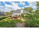 Enjoy the serene backyard featuring a covered patio, lush green lawn, and mature landscaping at 2678 Neighborhood S Walk, Villa Rica, GA 30180