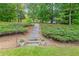 Lush backyard featuring a wooded trail and landscaped greenery at 2678 Neighborhood S Walk, Villa Rica, GA 30180