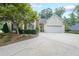 Charming home with a manicured lawn, mature landscaping, and a spacious two-car garage at 2678 Neighborhood S Walk, Villa Rica, GA 30180