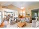 Bright living room featuring hardwood floors, neutral furniture, and an open layout to the kitchen at 2678 Neighborhood S Walk, Villa Rica, GA 30180