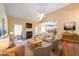 Open living room featuring a fireplace, hardwood floors, and seamless transitions to the kitchen and dining area at 2678 Neighborhood S Walk, Villa Rica, GA 30180