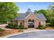 Charming pool house with brick accents, offering a gated entrance and shaded area at 2678 Neighborhood S Walk, Villa Rica, GA 30180