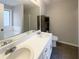 Bathroom featuring double sink vanity, large mirror, and combined tub and shower at 3151 Victoria Place Dr, Loganville, GA 30052