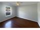 Cozy bedroom showcasing a large window and gleaming hardwood floors at 3151 Victoria Place Dr, Loganville, GA 30052