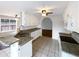 Updated kitchen featuring granite countertops, white cabinets, and stainless steel sink at 3151 Victoria Place Dr, Loganville, GA 30052
