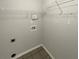 Neutral toned laundry room with tile floor and shelving at 3151 Victoria Place Dr, Loganville, GA 30052