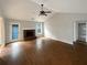 Bright living room featuring hardwood floors, fireplace, and vaulted ceilings at 3151 Victoria Place Dr, Loganville, GA 30052