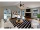 Staged living room with fireplace, hardwood floors, and an abundance of natural light at 3151 Victoria Place Dr, Loganville, GA 30052
