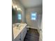 Well-lit bathroom featuring a modern vanity with a white countertop, sleek fixtures, and stylish flooring at 3392 Milan Ct, Douglasville, GA 30135
