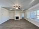 Spacious living room featuring a fireplace, ceiling fan, and large windows at 3392 Milan Ct, Douglasville, GA 30135