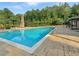 Community pool with well-maintained perimeter and adjacent wooden pergola and fireplace at 3392 Milan Ct, Douglasville, GA 30135