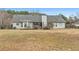 Exterior shot of the backyard with a covered patio, a grassy area, and a privacy fence at 40 Berkshire Run, Covington, GA 30016