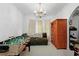 Versatile bonus room with a sofa, foosball table, chandelier, and cat tree at 40 Berkshire Run, Covington, GA 30016
