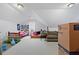 Bonus room with a sloped ceiling and furniture and items piled around the perimeter of the room at 40 Berkshire Run, Covington, GA 30016