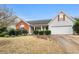 Well-maintained single-Gathering home with a two-car garage and landscaped front yard on a sunny day at 40 Berkshire Run, Covington, GA 30016