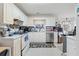 Functional kitchen with white cabinetry, stainless steel dishwasher, and laminate countertops at 40 Berkshire Run, Covington, GA 30016