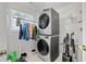 Laundry room with a stacked washer and dryer, a wire shelf, and a hanging clothes rack at 40 Berkshire Run, Covington, GA 30016