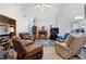 Cozy living room with a brick fireplace, comfortable seating, and an open view into the kitchen at 40 Berkshire Run, Covington, GA 30016