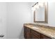 Bathroom vanity featuring a granite countertop, dark cabinetry, and decorative lighting fixture at 1421 Peachtree Ne St # 310, Atlanta, GA 30309