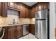 Modern kitchen featuring stainless steel appliances and sleek, dark wood cabinetry at 1421 Peachtree Ne St # 310, Atlanta, GA 30309