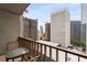 Balcony view facing buildings, complete with outdoor chairs and a glass table at 145 15Th Ne St # 1430, Atlanta, GA 30309