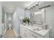 Bright bathroom featuring a double sink vanity, large mirror, and a glass-enclosed shower at 145 15Th Ne St # 1430, Atlanta, GA 30309