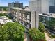 Exterior view of the building featuring a tree-lined street and city skyline backdrop at 145 15Th Ne St # 1430, Atlanta, GA 30309