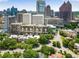 An aerial view of a city skyline, with surrounding trees and neighborhood streets below at 145 15Th Ne St # 1430, Atlanta, GA 30309