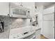 Modern kitchen with white cabinets, marble countertops, and stainless steel microwave at 145 15Th Ne St # 1430, Atlanta, GA 30309