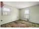 A bedroom featuring two windows with white shutters and aged green carpet at 1523 Delia Dr, Decatur, GA 30033