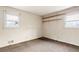 View of the bedroom featuring two windows that provide natural light and wooden shelves at 1523 Delia Dr, Decatur, GA 30033