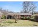 Quaint one-story brick house features a tidy front lawn and classic architectural details at 1523 Delia Dr, Decatur, GA 30033