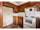 A kitchen featuring vintage wooden cabinetry and an outdated white stove at 1523 Delia Dr, Decatur, GA 30033