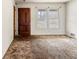 Empty living room featuring a wooden front door and bright windows, awaiting renovation at 1523 Delia Dr, Decatur, GA 30033