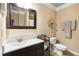 Neutral bathroom featuring dark wood cabinets and a framed mirror at 1624 Duncan Nw Dr, Atlanta, GA 30318