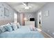 Bedroom featuring soft blue walls, ceiling fan, and lots of bright, natural light at 1624 Duncan Nw Dr, Atlanta, GA 30318