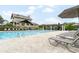 Community pool with lounge chairs and pergola and clubhouse in the background at 1624 Duncan Nw Dr, Atlanta, GA 30318