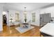 Elegant dining area with a modern chandelier, natural light, and stainless steel refrigerator in the background at 1624 Duncan Nw Dr, Atlanta, GA 30318