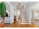 Bright foyer features hardwood floors, staircase, and views into the adjacent living and dining areas at 1624 Duncan Nw Dr, Atlanta, GA 30318