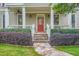 Inviting front porch with stone steps, lovely landscaping, and a welcoming red front door at 1624 Duncan Nw Dr, Atlanta, GA 30318