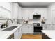 Well-lit kitchen showcasing white cabinetry, stainless steel appliances, and a subway tile backsplash at 1624 Duncan Nw Dr, Atlanta, GA 30318