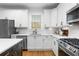 Modern kitchen with stainless steel appliances, white cabinets, and a contrasting island with a quartz countertop at 1624 Duncan Nw Dr, Atlanta, GA 30318