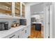 Butler's pantry between kitchen and dining room, with quartz countertops and beverage center at 1624 Duncan Nw Dr, Atlanta, GA 30318