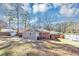 Backyard view of the home and shed, with lawn at 2187 Freydale Se Rd, Marietta, GA 30067