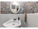 Bright bathroom showcasing a classic white vanity sink, decorative mirror, and tiled walls at 2187 Freydale Se Rd, Marietta, GA 30067